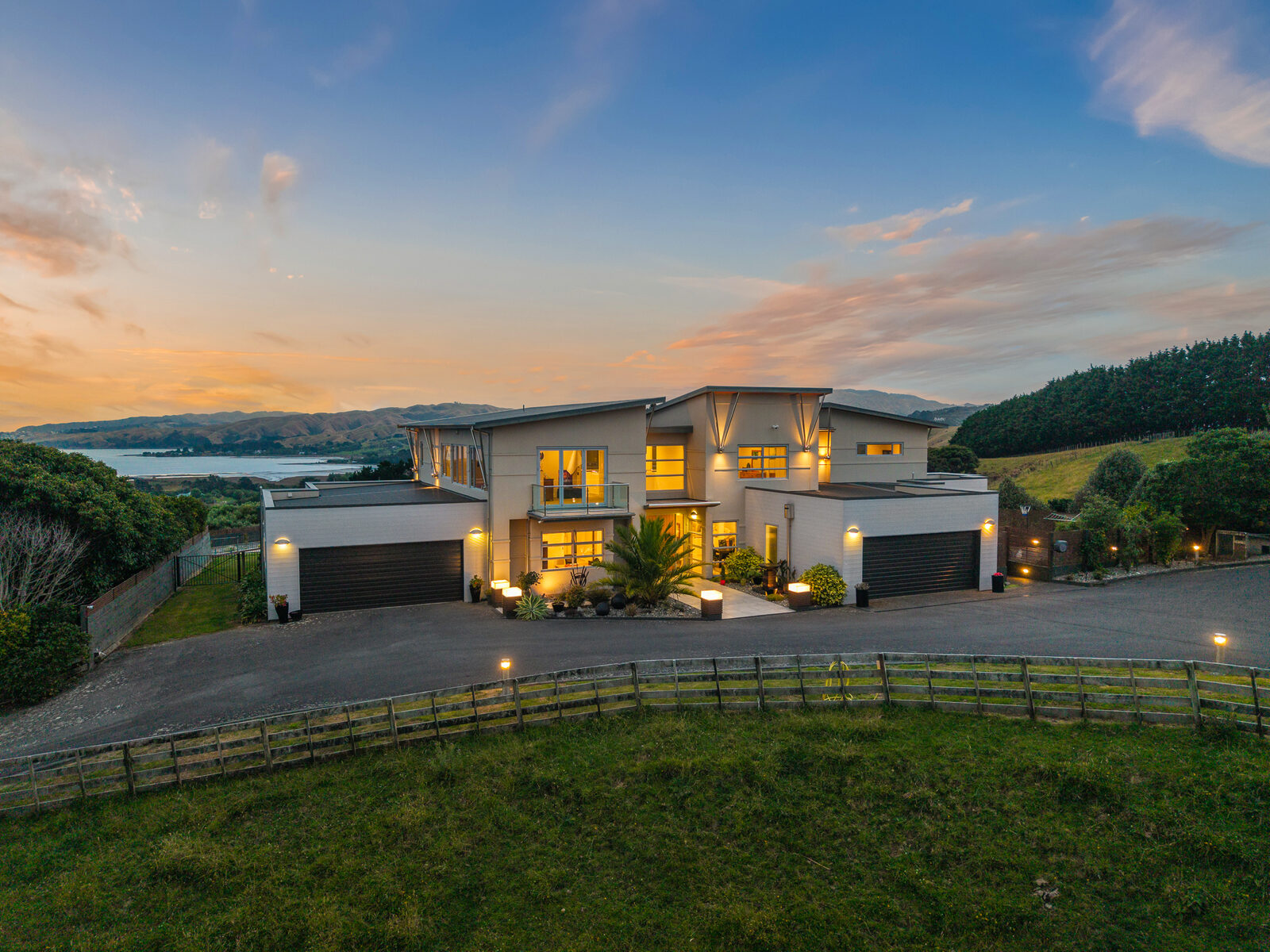 Aerial twilight — hillside home with city views