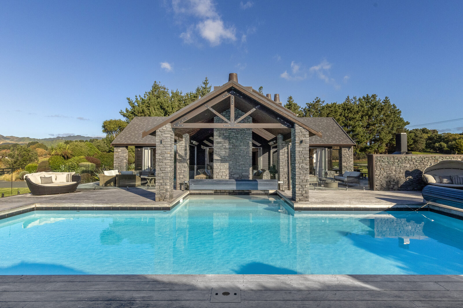 Resort-style pool with stone pavilion