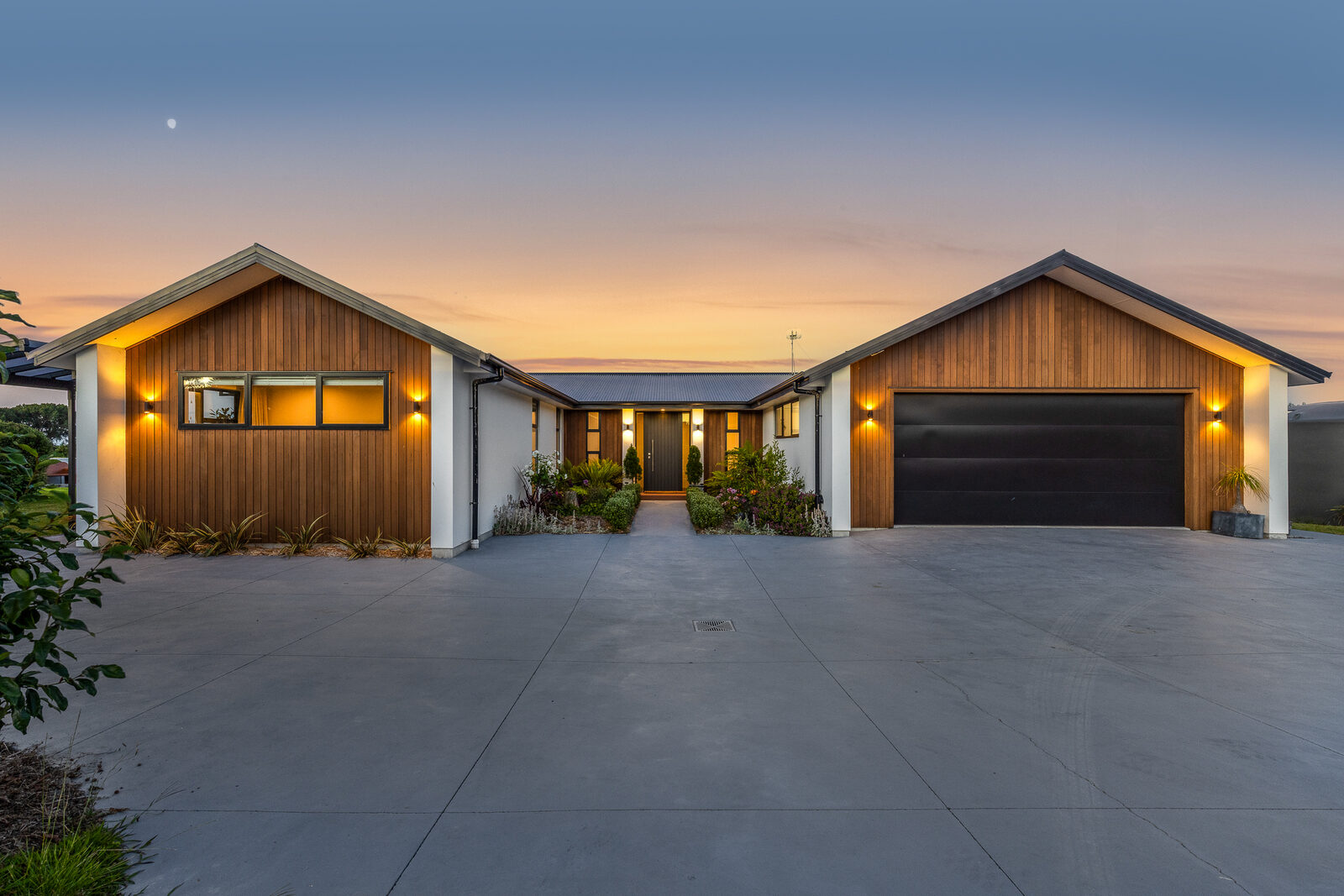 Twilight exterior — triple garage driveway